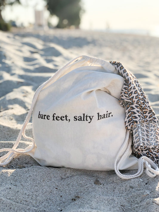 Bare feet, salty hair backpack